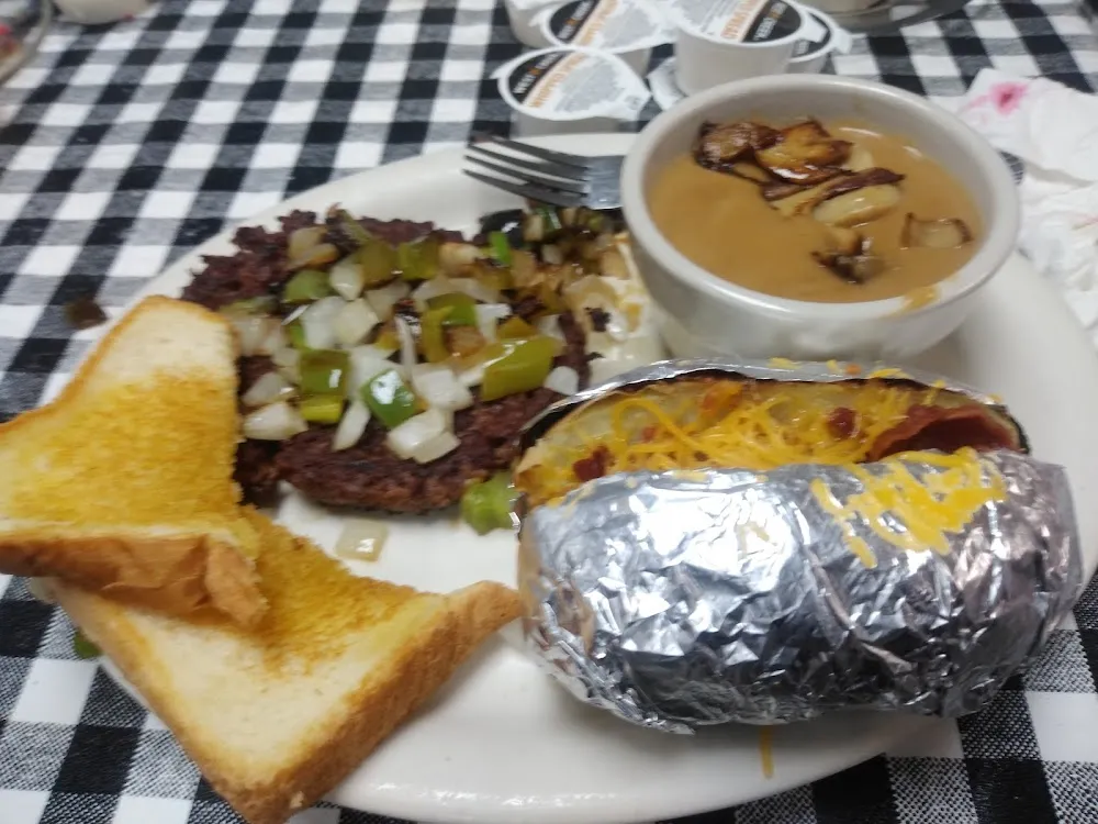 Chopped Steak Smothered in Mushroom Gravy Peppers and Onions